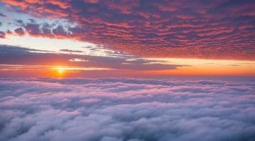 The sun is setting over the clouds in the sky The sun is setting over the clouds in the sky